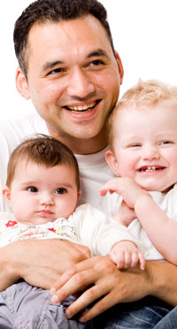 smiling father and sons